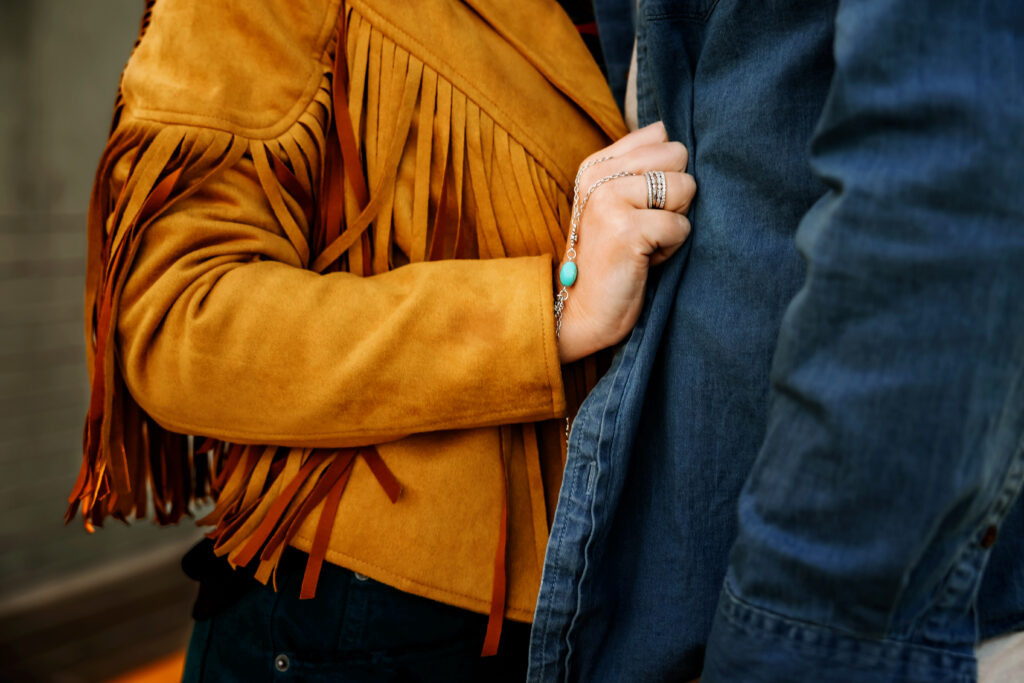 woman clutching man's denim jacket