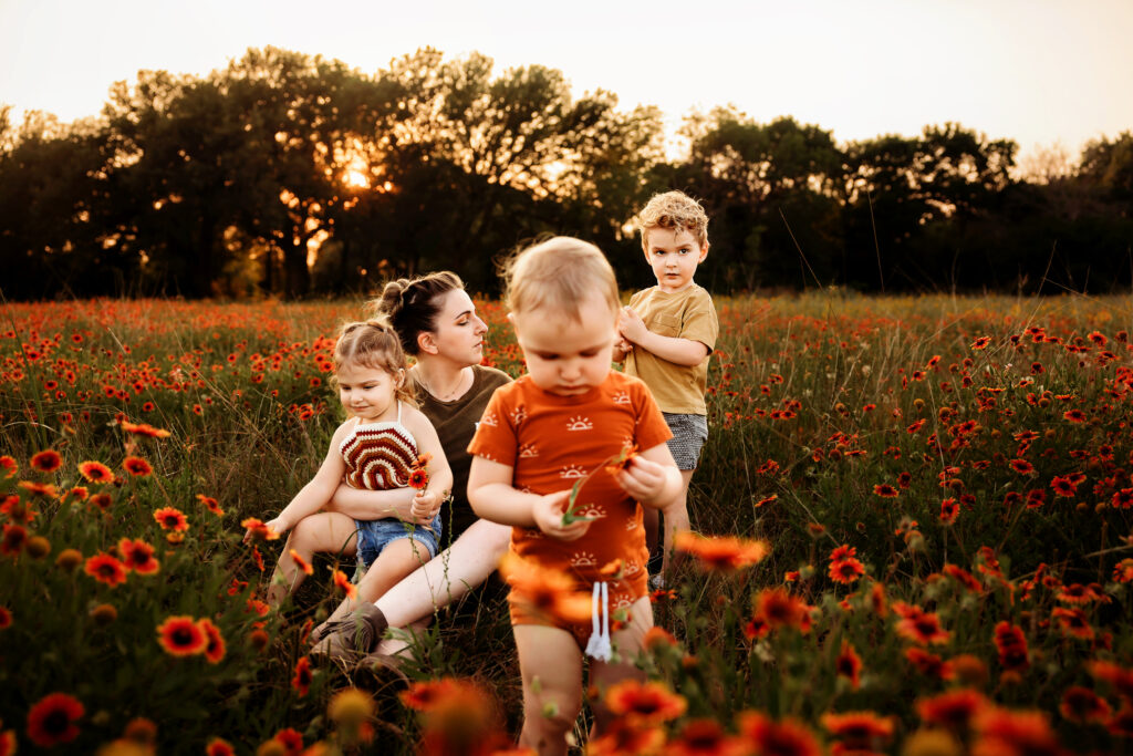 Children playing in a field of mexican hats at sunset