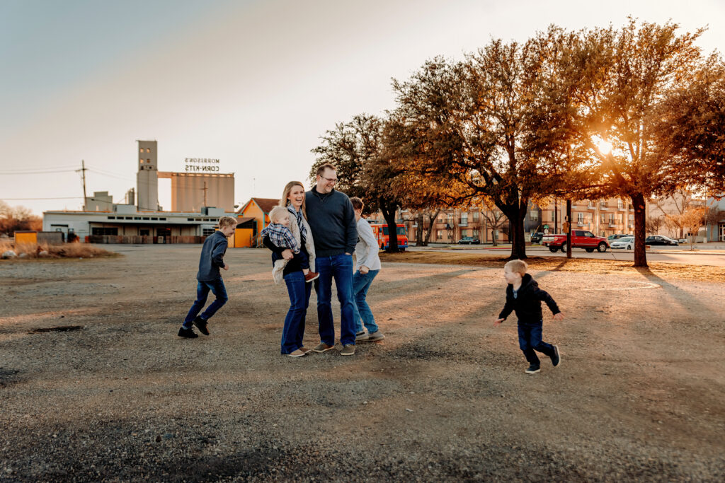 Family running around during a family session in fort worth texas