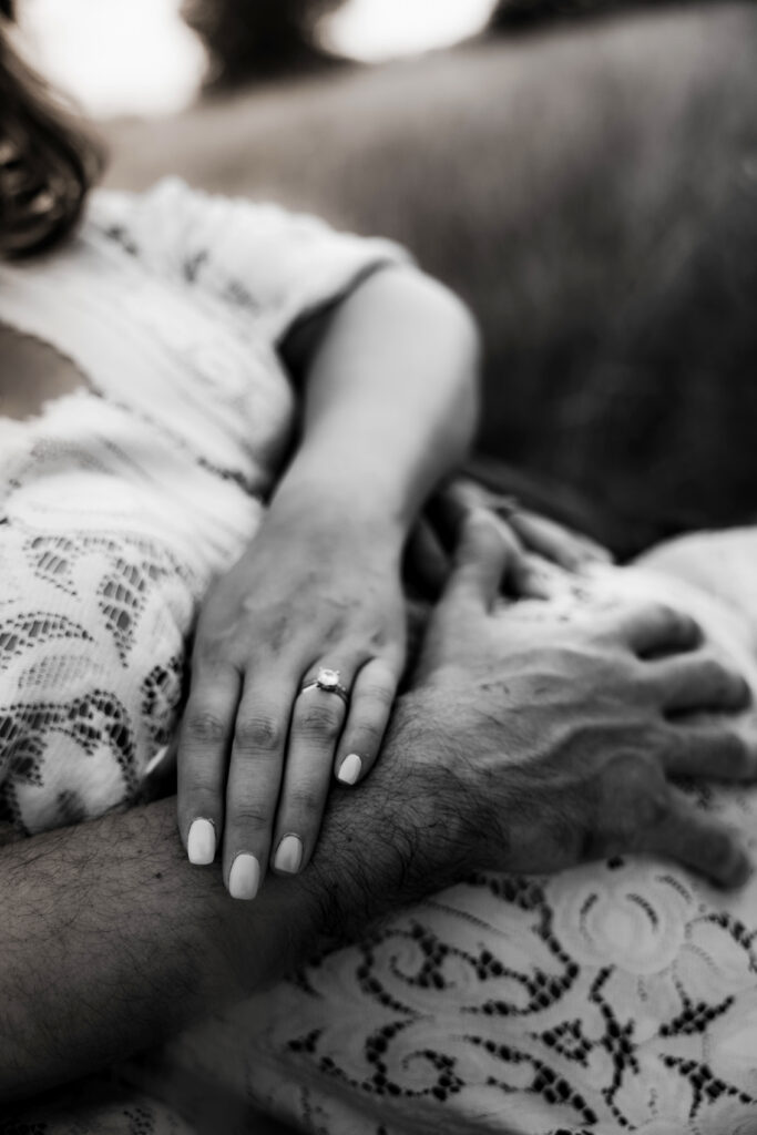 Black and White emotive image of mom holding dad's arm