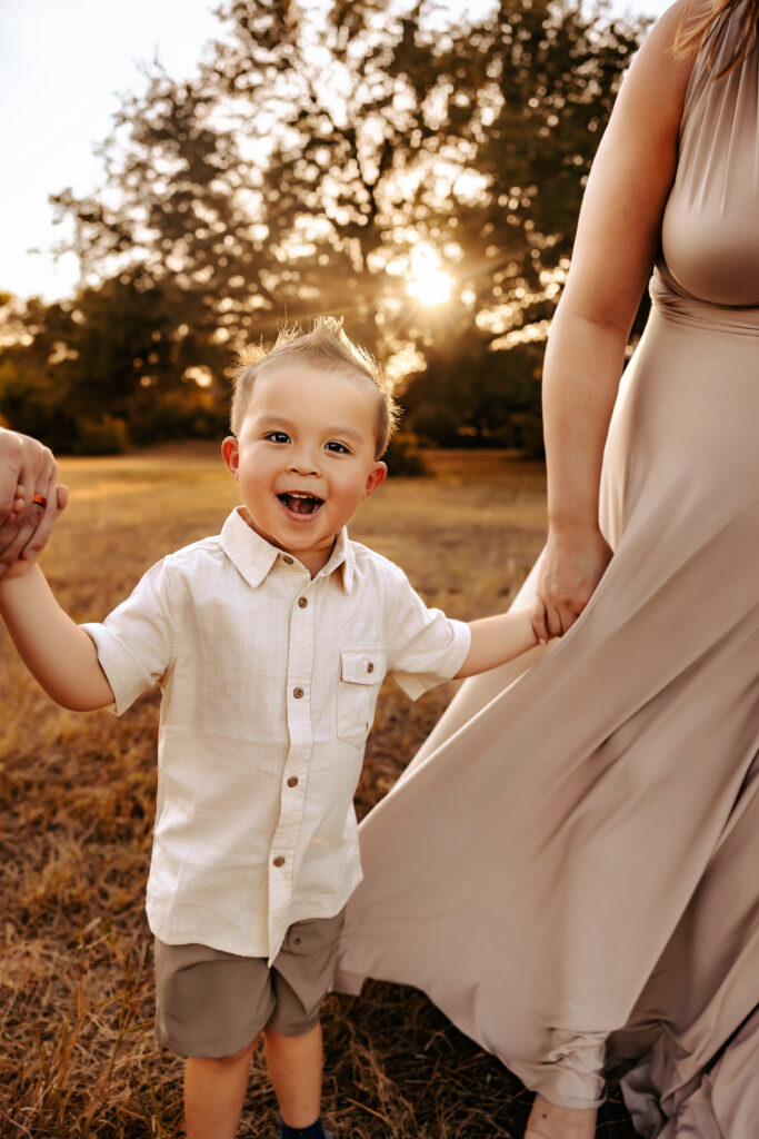 little boy smiling and laughing during a family session