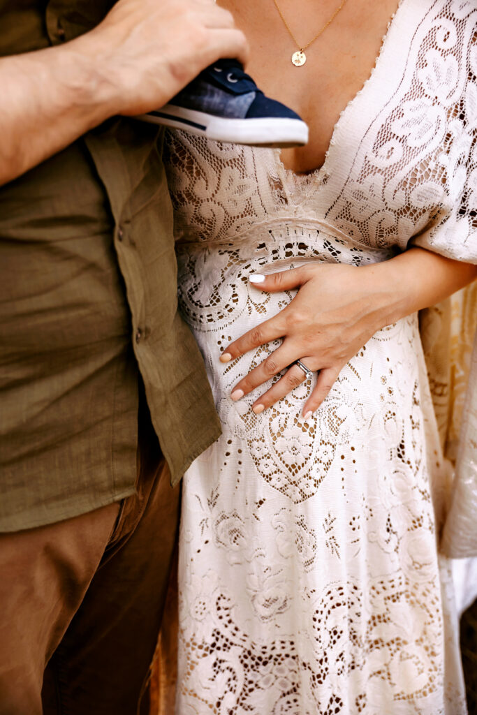 Detail image of Momma holding her baby bump during a full session in fort worth