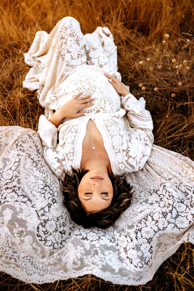 Pregnant Mother laying on the ground during a maternity session