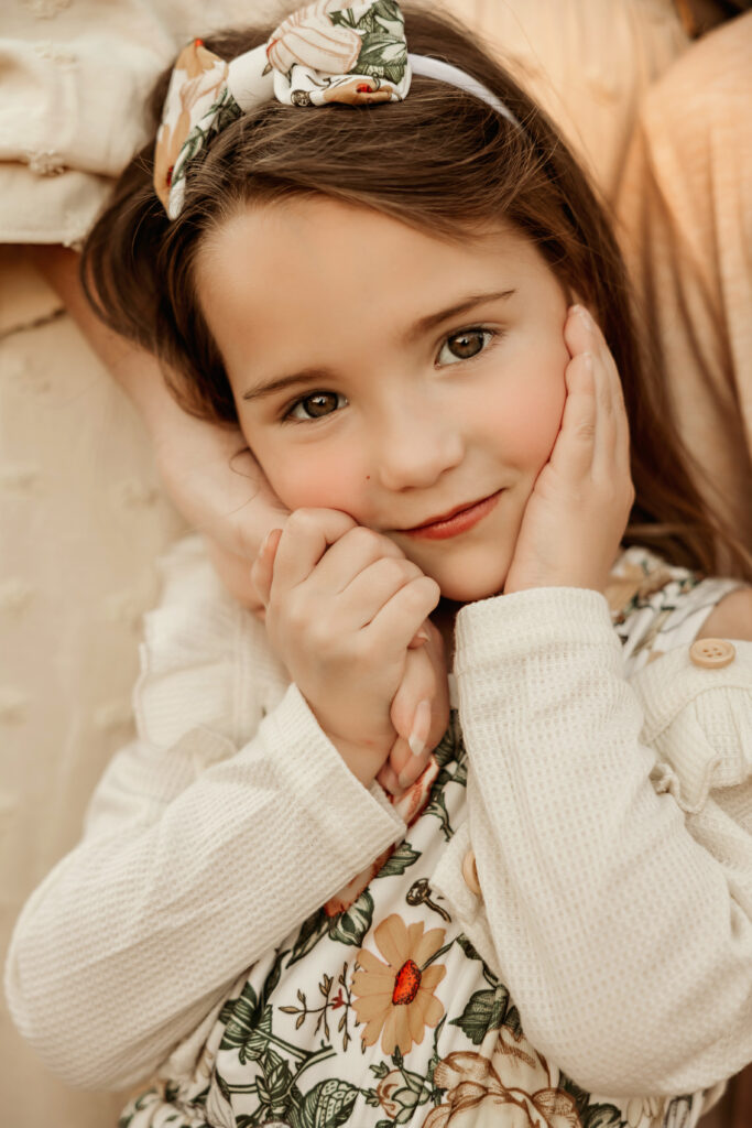 small girl shyly smiling at the camera