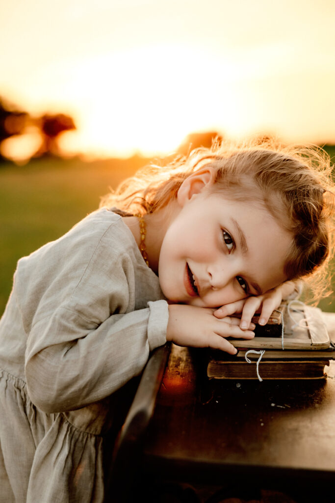 little girl smiling in the sunset