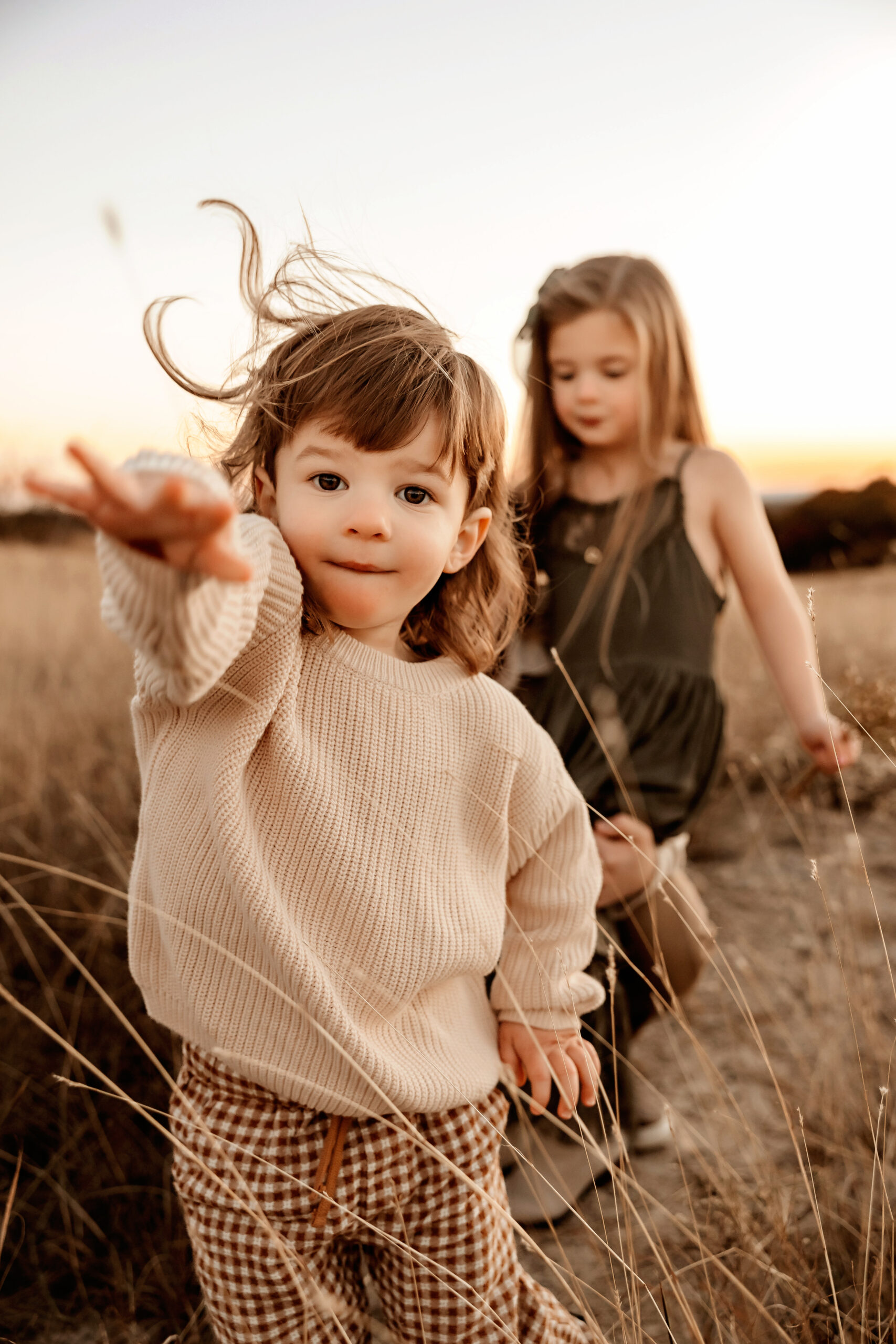 toddler boy throwing a rock