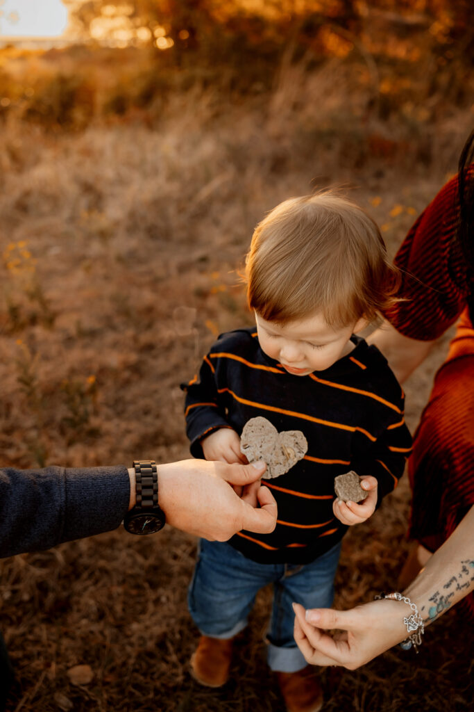 dad holding up a heart leaf to little boy