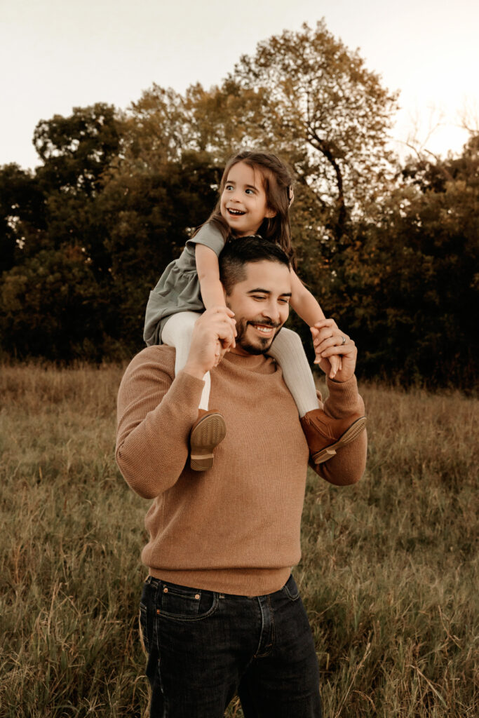 father and daughter playing during a fall family photo session