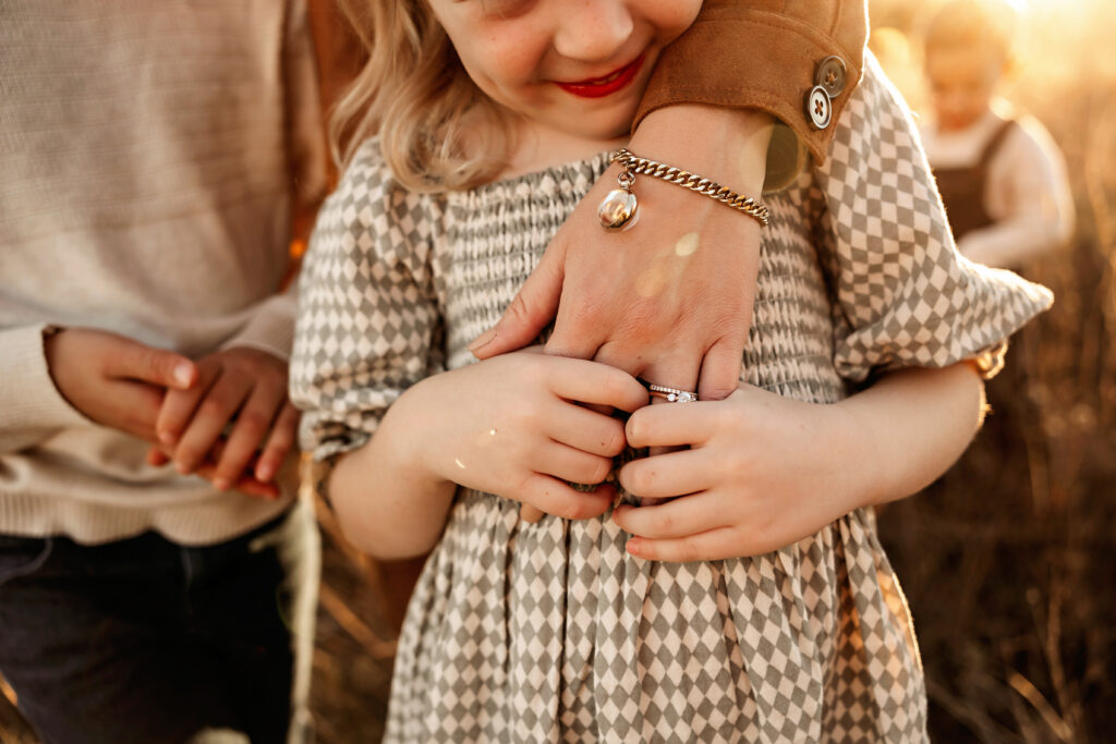 Close-up of child’s hands wrapped around mom’s hand – emotive family photography Fort Worth TX