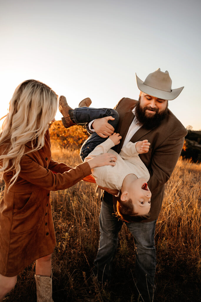 Dad tossing child in the air while mom tickles with a big smile – Fort Worth Family Photographer