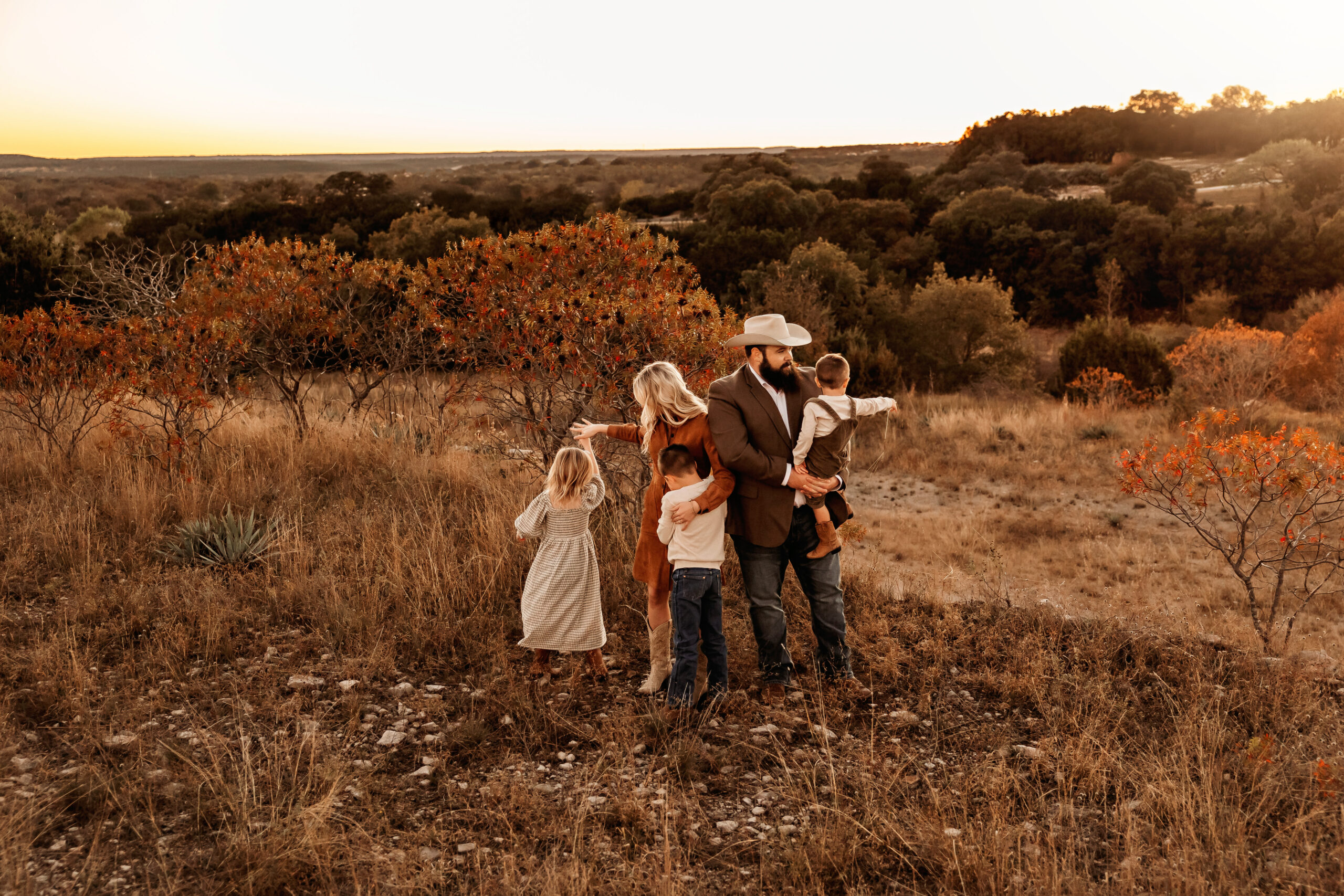 Candid moment of parents playing with their kids during family photos in Fort Worth