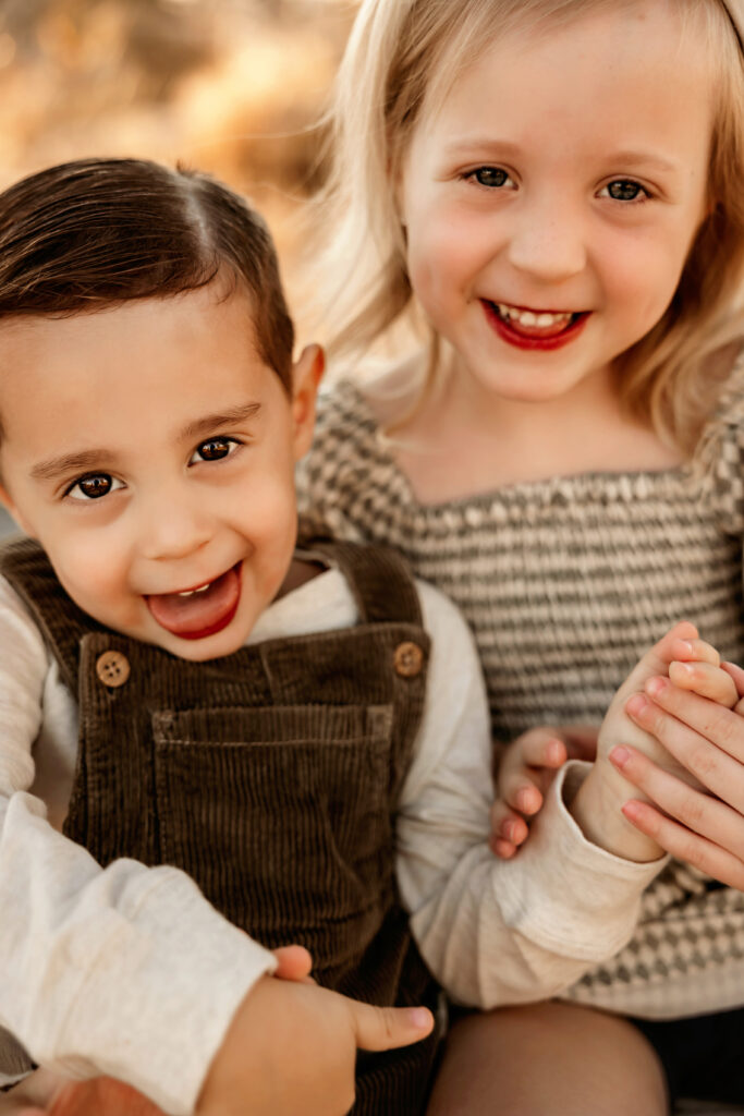 brother and sister smiling and laughing during a fort worth family photo session