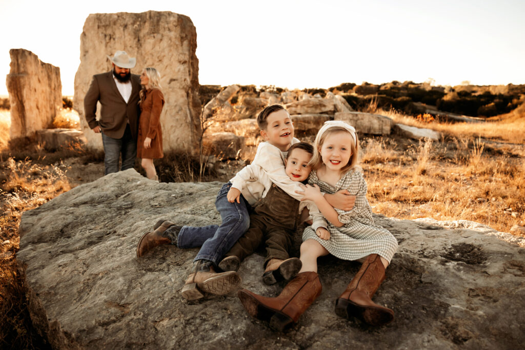 Family laughing together in golden hour light at a Fort Worth outdoor session