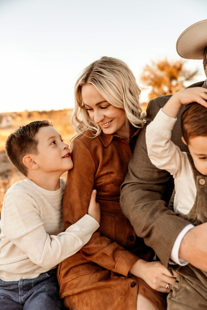 mom smiling at her son during a fort worth family sunset photoshoot