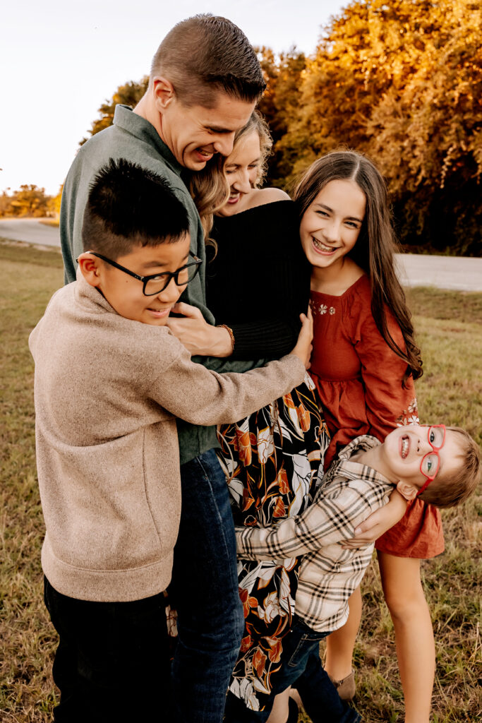 Family cuddling together at sunset during Fall Mini Session in Fort Worth TX