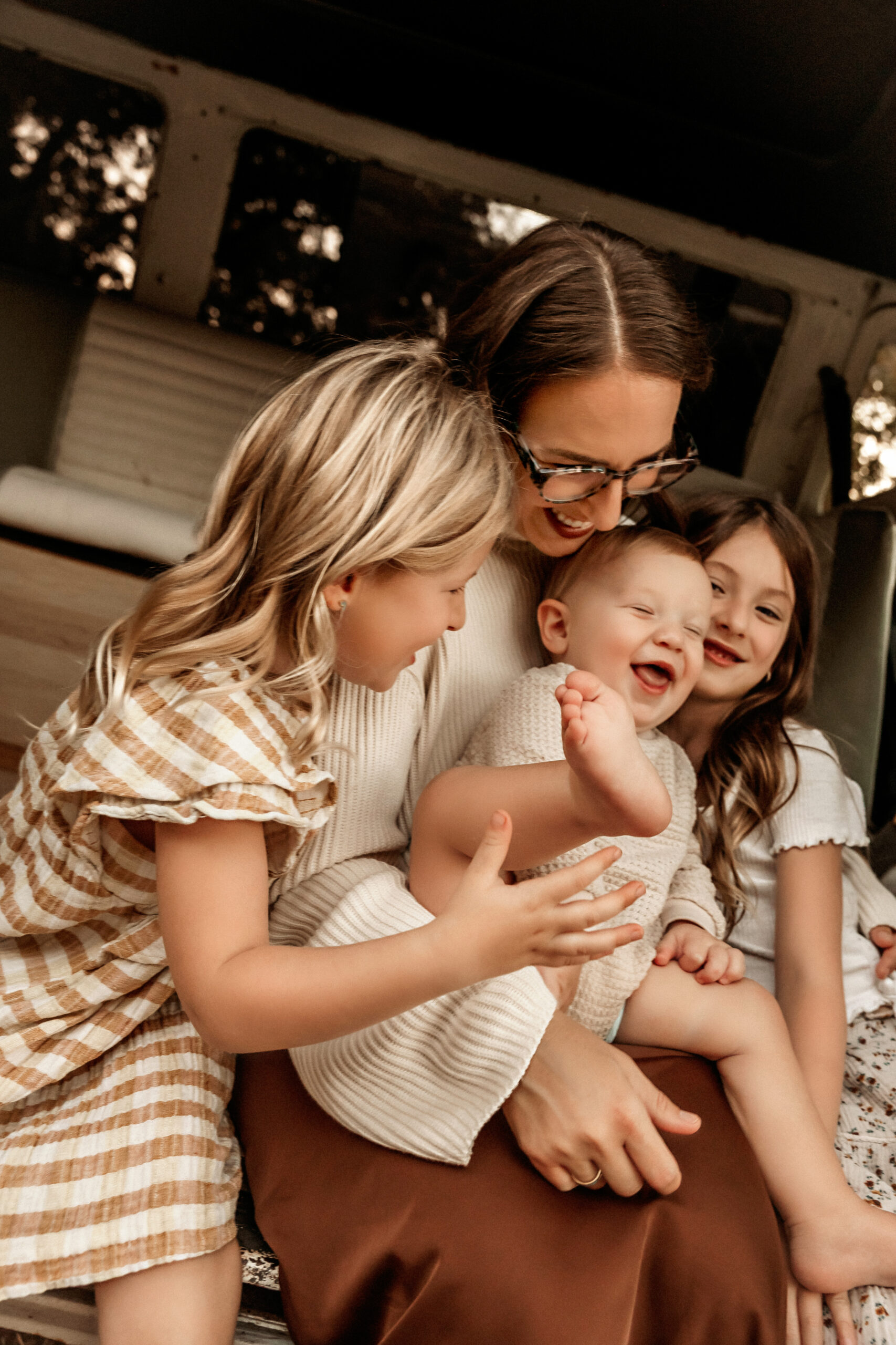 family tickling the youngest baby while at a family session in Fort Worth Texas