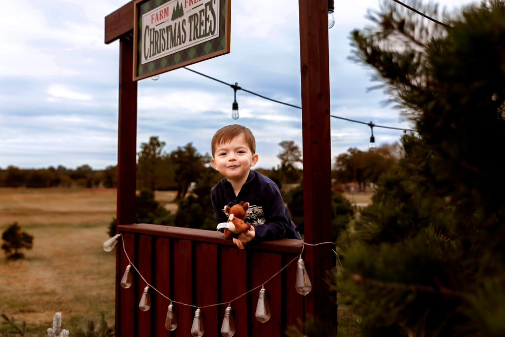 kid being goofy during a christmas tree mini in fort worth texas
