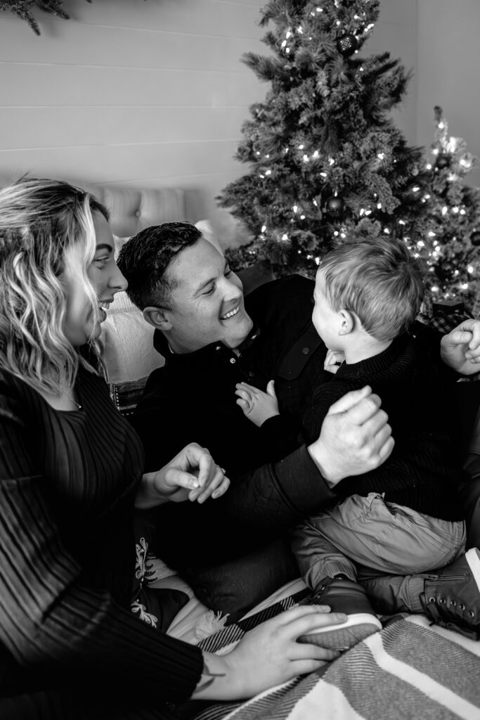 Parents and child sharing a sweet moment at styled Christmas mini session in DFW