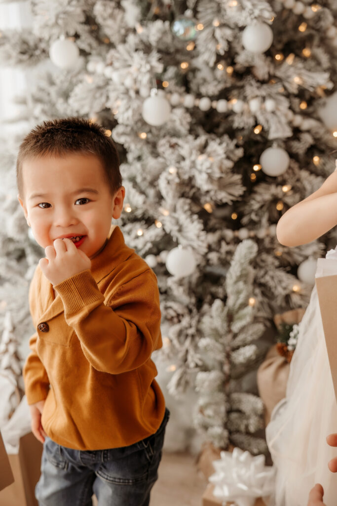 Kid laughing during indoor Christmas family photo shoot