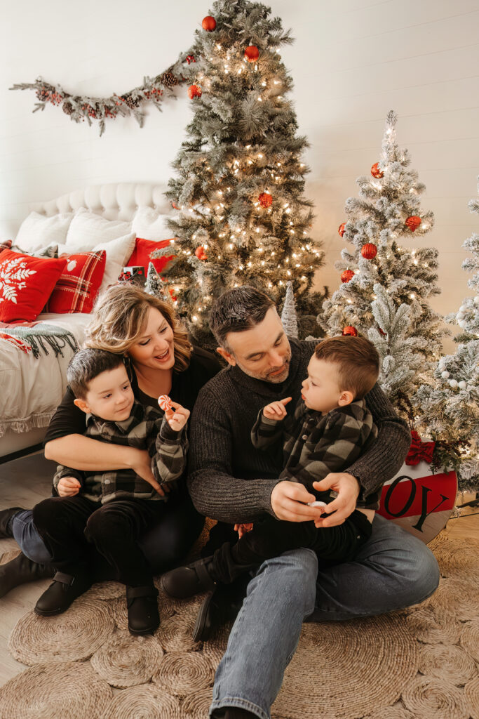 Kids laughing together during outdoor Christmas family photo shoot