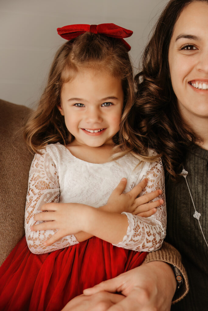 Girl smiles during a Christmas studio mini session in fort worth texas